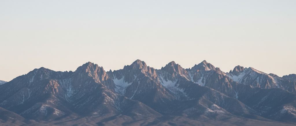 A distant mountain ridge line against a pale sky, nothing in the foreground